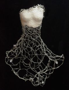 a mannequin is covered with wire and beads