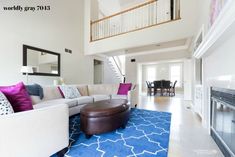 a living room filled with furniture and a blue rug