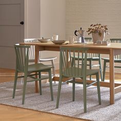 a wooden table with four chairs around it