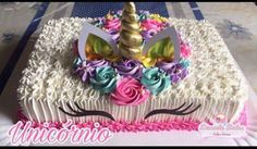 a cake decorated with flowers and a unicorn horn