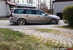 a silver car parked in front of a house