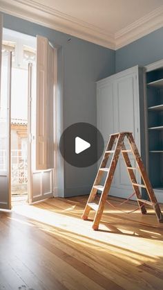 an empty room with a ladder leaning against the wall