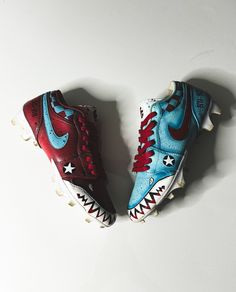 two pairs of shoes with red, white and blue paint on them sitting next to each other