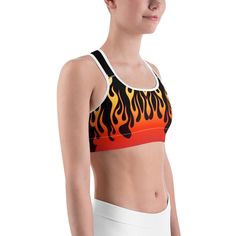 Phwar, Hot Dang, the Gearbunch Flame Sports Bra 
Make a statement & maybe move a little faster in this bold black sports bra with rising red, orange and yellow flames.
This gorgeous sports bra is made from moisture-wicking material that stays dry during low and medium intensity workouts. The bra has support material in the shoulder straps, double layer front, and a wide elastic band to ensure constant support.

Wear to yoga, the gym, or wherever makes you feel good.
Be Happy, Be Bright, Be You w Functional Orange Sports Bra For Training, Orange Activewear For Sports, Red Racerback Sports Bra For Gym, Breathable Orange Activewear For Sports, Red Racerback Sports Bra For Workout, Fitted Orange Sports Bra For Gym, Functional Orange Sports Bra For Workout, Orange Sporty Sports Bra For Gym, Orange Athleisure Sports Bra For Workout