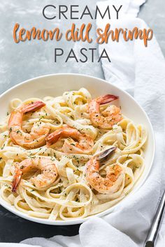 creamy lemon dill shrimp pasta in a white bowl with a fork on the side