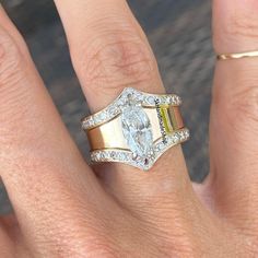 a woman's hand with two rings on it and a diamond in the middle