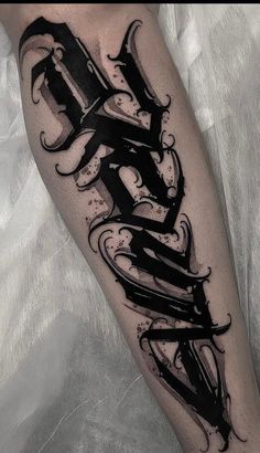 a black and white tattoo design on the leg