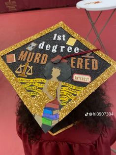 a woman wearing a graduation cap with the words, 1st degree murdered on it in gold glitter