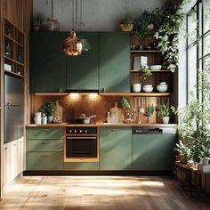 a kitchen with green cabinets and plants on the counter top, along with wooden flooring