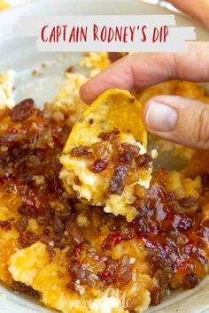 a person is dipping some food into a bowl