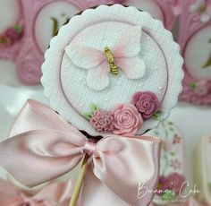 a close up of a cake topper on a plate with flowers and a butterfly