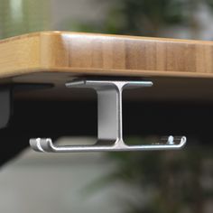 a close up view of a wooden table with metal brackets on the top and bottom