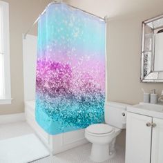 a bathroom with a blue and pink shower curtain