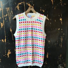 "Fantastic vintage 60's/70's mod colorful square pattern knit sleeveless sweater top. Longer fit, but can be tucked in nicely. 100% acrylic. In good vintage condition. Made by RJ Pumpkin. Will best fit medium. Measurements laying flat: fabric stretches Armpit to armpit: 18\" Length: 25\"" Multicolor Fitted Retro Tank Top, Fitted Multicolor Knit Vest, Fitted Multicolor Knit Sweater Vest, Fitted Multicolor Sweater Vest For Fall, Multicolor Knit Sleeveless Vest, Retro Multicolor Sleeveless Vest, Multicolor Knit Vest Top, Multicolor Sleeveless Vest For Fall, Multicolor Sleeveless Sweater Vest For Fall