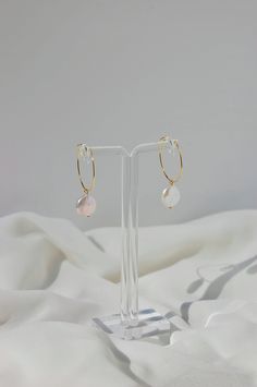 These dainty dangle earrings are made with freshwater coin pearls and 18 karat gold plated hoops. This gold plating protects against wear and tear, tarnishing, and light contact with substances such as water. All earrings are handcrafted with care and custom made to meet your unique needs. Closure options: * Pierced closures are hypoallergenic and nickel free. * Clip on closures are made of acrylic/plastic which makes for an invisible look. They are also hypoallergenic and nickel free. How to we Circle-shaped Pearl Drop Jewelry Gift, Pearl Drop Jewelry Gift In Circle Shape, Pearl White Dangle Hoop Earrings With Pearl Charm, Single 14k Gold-filled Round Pearl Earring, Minimalist Round Earrings With Pearl Charm, Nickel-free Round Pearl Earrings In 14k Gold, White Dangle Hoop Earrings With Pearl Charm, Dangle Hoop Earrings With Pearl Charm For Gift, Adjustable Hoop Pearl Drop Earrings