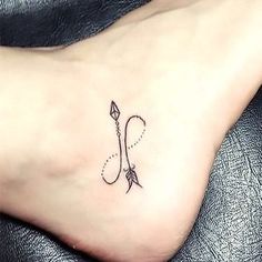 a woman's foot with a small tattoo on the left side of her leg