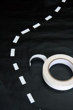 a close up of a white object on a black surface with circles and squares around it