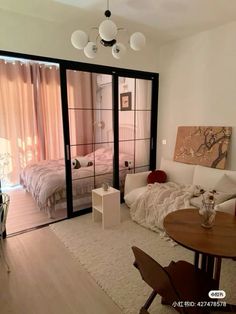 a living room filled with furniture and a sliding glass door leading to a bedroom area