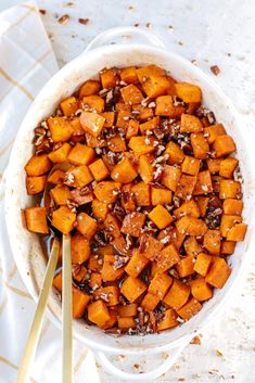 a white bowl filled with cooked sweet potatoes