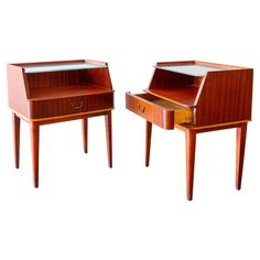 two small wooden tables with drawers on each side, one is open and the other has a drawer