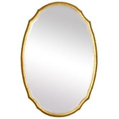 an oval mirror with gold trimmings and a white background