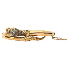 This magnificent antique creation of the Victorian era is a reptile bracelet dating from the mid-to-late 19th century - the snake is artfully created in yellow gold and set with ruby eyes and the serpent head is inlaid with old cut diamonds. It is a light hollow hinged bangle bracelet. The head and tail of this reptile have an ornate floral design while the rest of the gold is structured which resembles the scales of the snake. The bangle is slightly oval shaped with a side hinge, there is a sma Luxury Victorian Gold Bracelet, Serpent Jewelry, The Victorian Era, The Serpent, Heads And Tails, Snake Bracelet, The Snake, Queen Victoria, Hinged Bangle