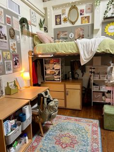 a dorm room with a bed, desk and rug on the floor in front of it