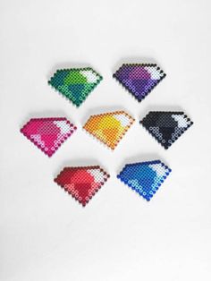 six different colored diamond shapes on a white surface