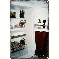 an open refrigerator filled with lots of different types of shoes and purses on shelves