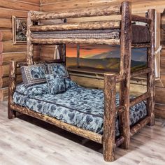 a rustic log bed in a bedroom with wood flooring and wooden walls, along with pictures on the wall