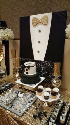 a table topped with lots of cupcakes and cakes