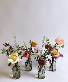 three vases filled with different types of flowers