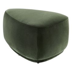 a large green ottoman sitting on top of a white floor