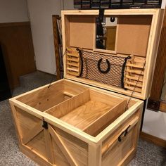 an open wooden box sitting on top of a floor