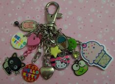 a bunch of different key chains on a pink background