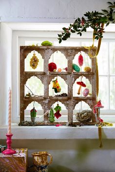 a window sill filled with ornaments and candles