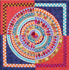 a colorful quilt with an abstract design on it