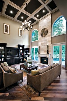 a living room filled with furniture and a fire place in the middle of a room