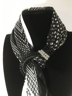 Black and white polka dot scarf blocked by a spiral of Swarovski beads and embellished with an embroidered ring and hard stone pendants. Materials 100% viscose scarf Spiral in Swarovski Fancy hard stones Embroidered crochet ring This women's scarf is perfect for you or for an original and unique gift, to surprise and please. It is advisable to wash it by hand in order to preserve the jewelry. Delivery Sending parcelsimo Delivery available from $120 purchase The scarves are sent in their pouch wi Handmade Elegant Scarves One Size, Elegant Handmade White Silk Scarf, Elegant White Handmade Silk Scarf, Embroidered Ring, Crochet Ring, Embroidered Crochet, Crochet Rings, Polka Dot Scarf, Swarovski Beads