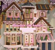 a large pink house with lots of windows and balconies on the top floor