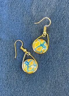 "Sun + Sea" earrings: Golden yellow with blue and white lacing.  Gold-tone Stainless steel hypoallergenic French hook.  3/4"L x 1/2" W. Sea Earrings, Earrings Golden, Golden Yellow, Jewelry Earrings Dangle, Etsy Earrings, Dangle Drop Earrings, Gold Tones, Dangle Earrings, Jewelry Earrings