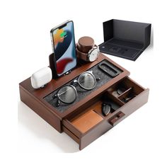 an iphone is sitting in a wooden box with other items inside it and on top of the case