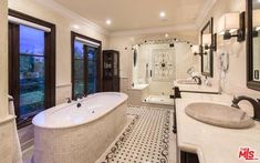 a large bathroom with two sinks and a bathtub