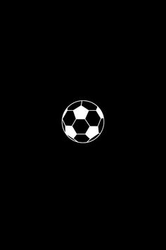 a black and white photo of a soccer ball in the dark, with only one ball visible