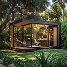 a person sitting at a desk in a glass walled office surrounded by greenery and trees