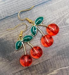 Beautiful handmade cherry glass dangle earring charms are the perfect accessory for your summer outfit! Grab your unique jewelry treasures today before this rare item is gone! Thank you so much for supporting my shop and helping us be able to create more beautiful unique jewelry treasures!  WHAT YOU GET: Handmade cherry glass charm dangle earrings will come packaged with care in a gifted jewelry box, where you can either keep your jewelry inside to store when you're not wearing it, or the gift b Trendy Handmade Cherry-colored Jewelry, Retro Dangle Earrings Gift, Retro Dangle Earrings For Gift, Handmade Cherry Jewelry For Party, Retro Handmade Drop Earrings, Retro Drop Earrings Jewelry Gift, Cute Red Handmade Jewelry, Nickel-free Retro Dangle Earrings, Cherry Colored Drop Earrings With Ear Wire