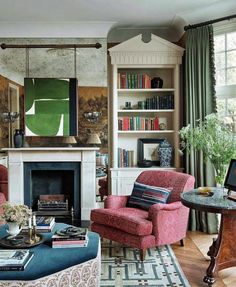 a living room filled with furniture and a fire place in front of a book shelf