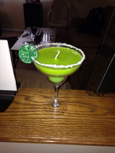 a green drink with a shamrock on the rim