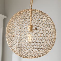 a light that is hanging from the ceiling in a room with white walls and windows