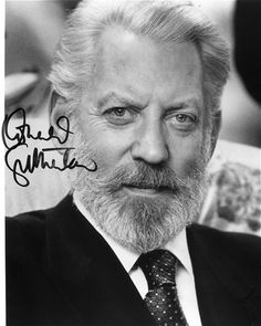 an old black and white photo of a man with a beard, wearing a suit